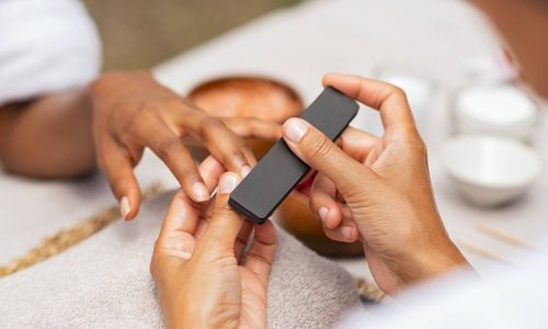 woman-using-a-buffer-to-file-nail